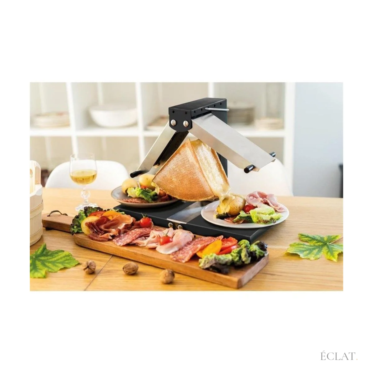 Raclette servie à la meule sur une planche de charcuterie et de pommes de terre